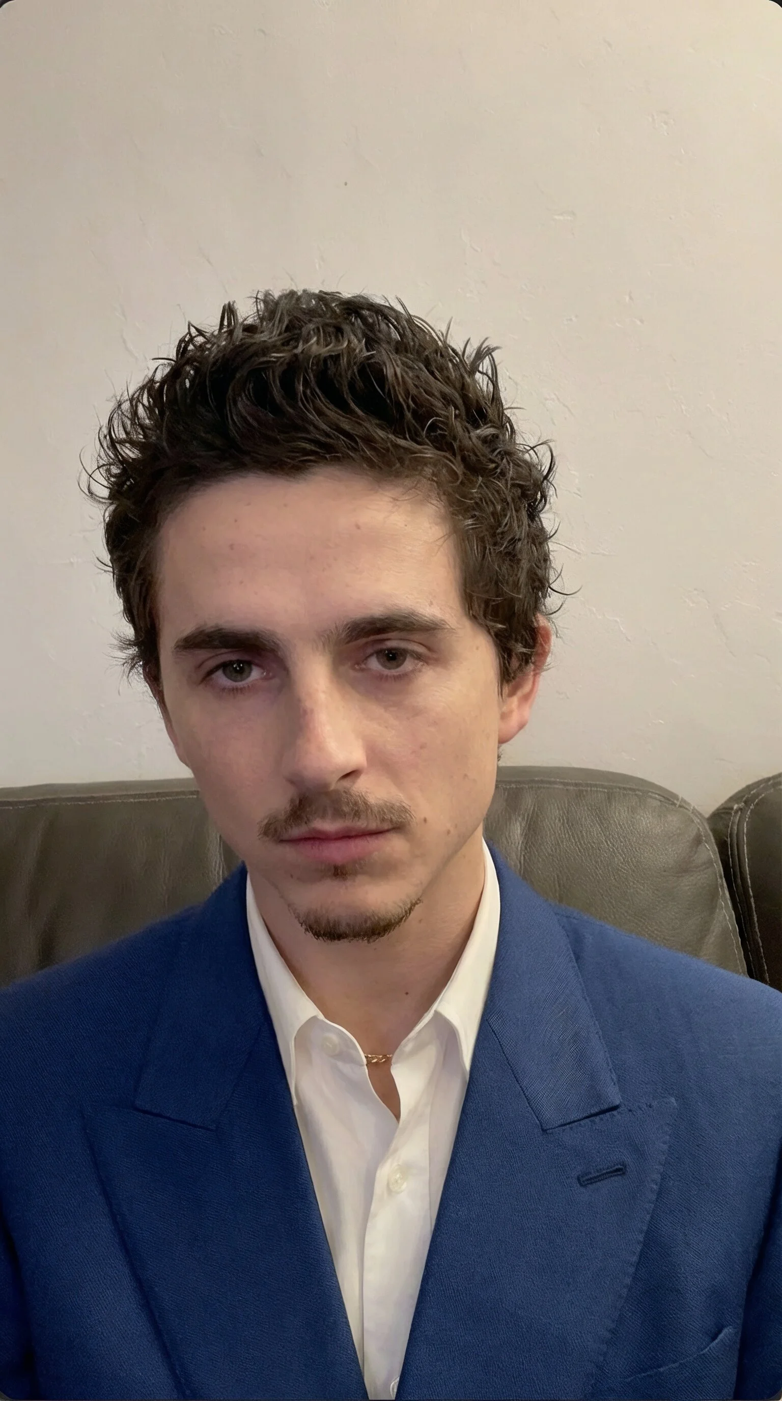 Source selfie of a man in a blue suit